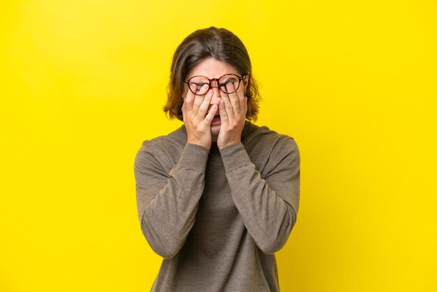 Homem bonito caucasiano isolado em fundo amarelo com expressão cansada e doente