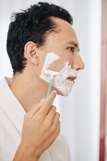 Homem bonito fazendo a barba