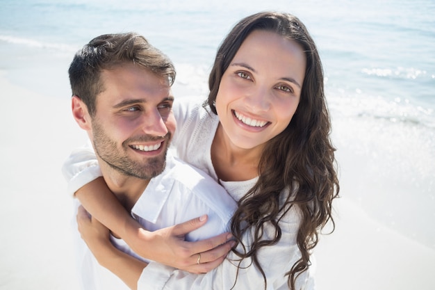 Homem bonito fazendo piggy-back para sua namorada