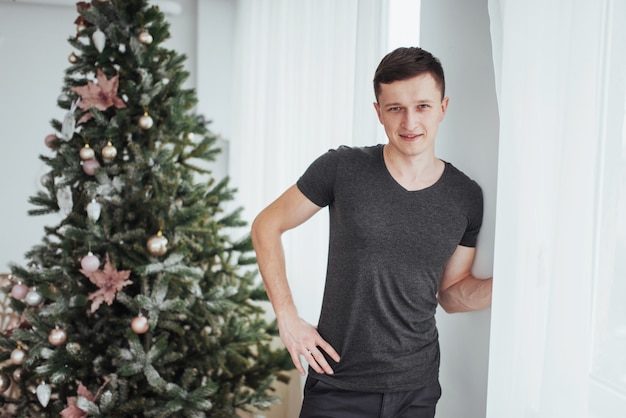 Homem bonito na camisa sorrindo. Dia de Natal