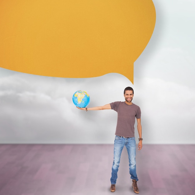 Homem bonito segurando um globo com balão contra nuvens em uma sala