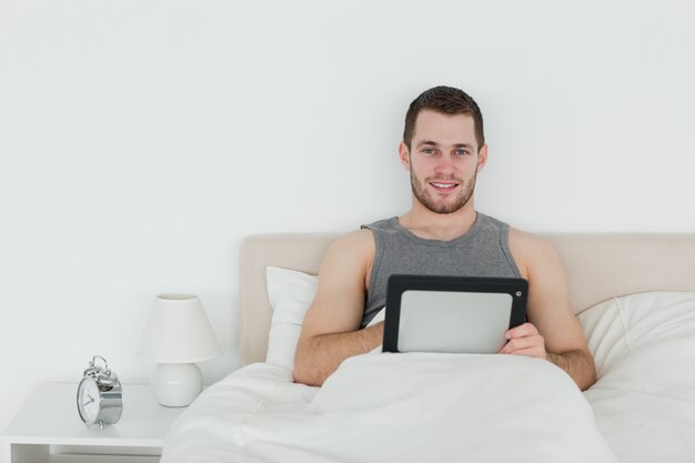 Homem bonito usando um tablet computador