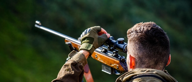 Homem caçador. Avistamento do atirador no alvo. Período de caça. Homem com uma arma. Fechar-se. Hunter com arma de caça e forma de caça para caçar. Hunter está mirando. O homem está à caça. Rifle de caça