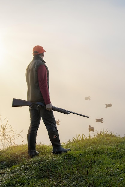 Homem caçando caçador de aves aquáticas