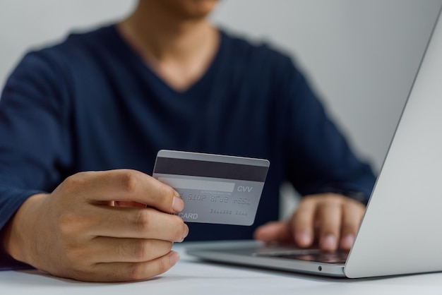 Homem com cartão de crédito na mão e homem de negócios ou e-commerce internet banking compras online.