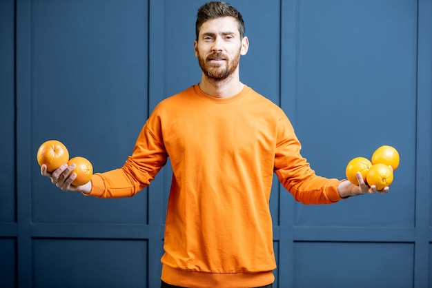 Homem com frutas no fundo azul