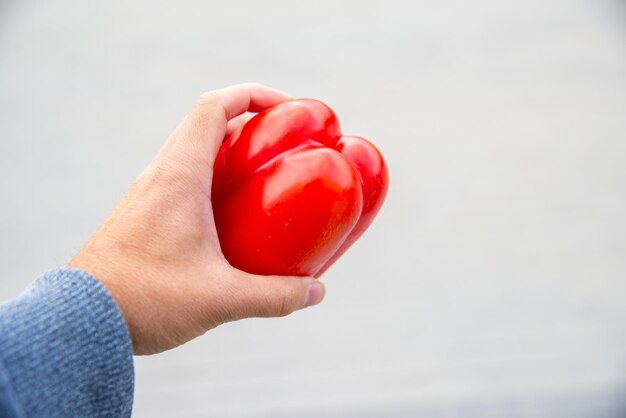 Foto homem com pimenta vermelha em fundo azulado