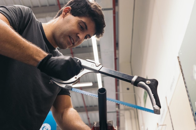 Foto homem com serra e luvas corta metal