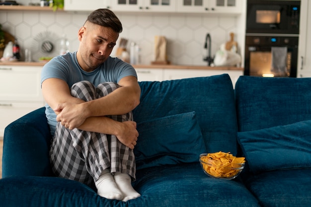 Foto homem com transtorno alimentar tentando comer batatas fritas