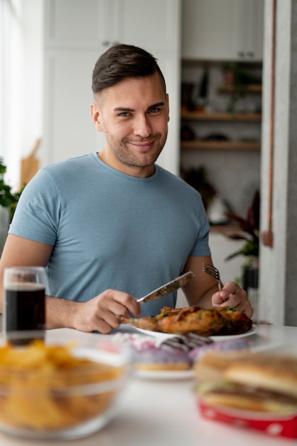 Homem com transtorno alimentar tentando comer frango