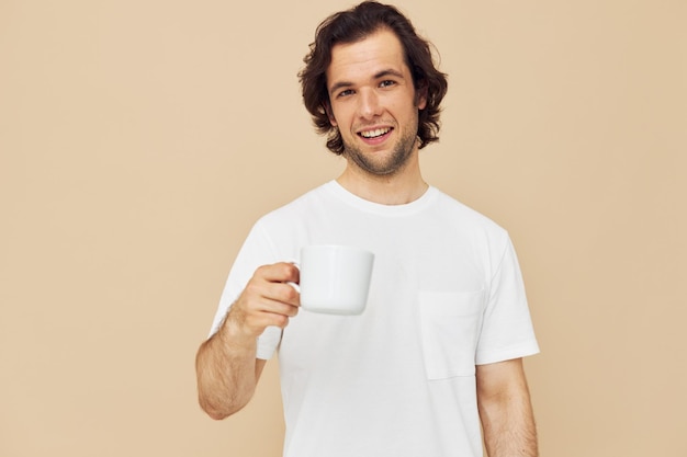 Homem com uma caneca branca nas mãos emoções posando de fundo isolado