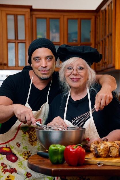 Homem cook com legumes sorrindo em casa