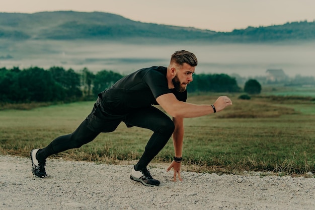 Homem correndo / correndo na estrada nas montanhas. Ajuste o corredor de fitness masculino durante treino ao ar livre. Homem caucasiano novo.