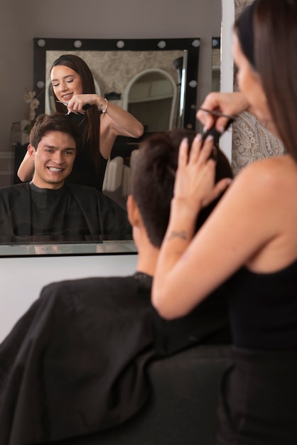 Foto homem cortando o cabelo no salão de cabeleireiro latino