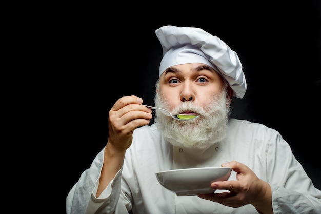 Homem cozinheiro prova comida