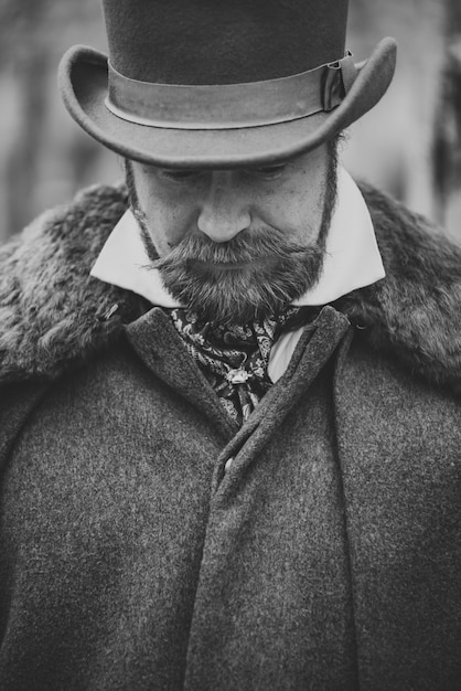 Homem de bigode respeitável em roupas retrô clássicas, casaco e chapéu.