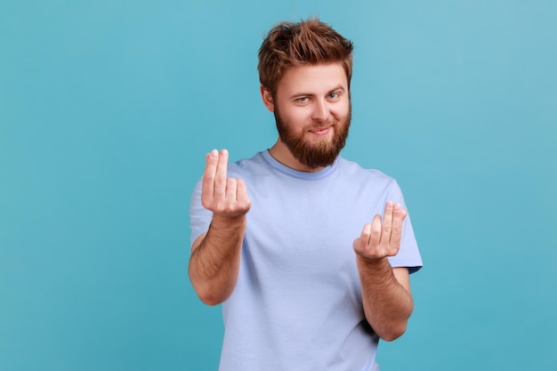 Homem de camiseta azul esfregando os dedos mostrando gesto de dinheiro pedindo salário exigindo suborno