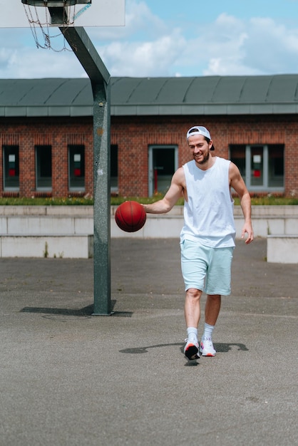 Foto homem de comprimento inteiro a jogar basquetebol.