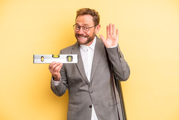 homem de meia idade sorrindo e parecendo amigável, mostrando o número um. arquiteto com um conceito de nível