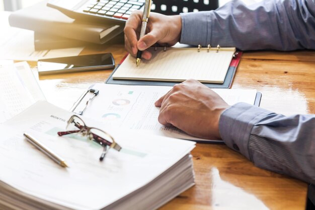 homem de negócios, analisando o gráfico e o documento de gráfico na mesa de escritório