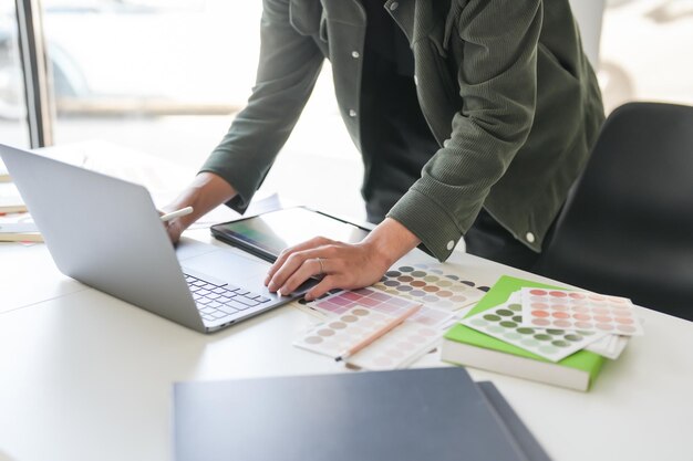 homem de negócios asiático artista designer criativo esboço desenho gráfico em laptop gráfico e amostras de amostras coloridas conceito de criatividade de ideia