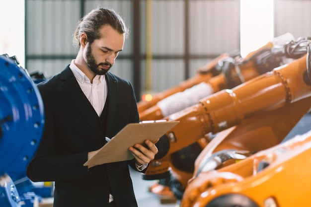 Homem de negócios que trabalha na fábrica de montagem de máquinas da indústria pesada para o homem de vendas de produtos de negócios industriais