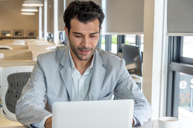 Homem de negócios usa laptop no local de trabalho