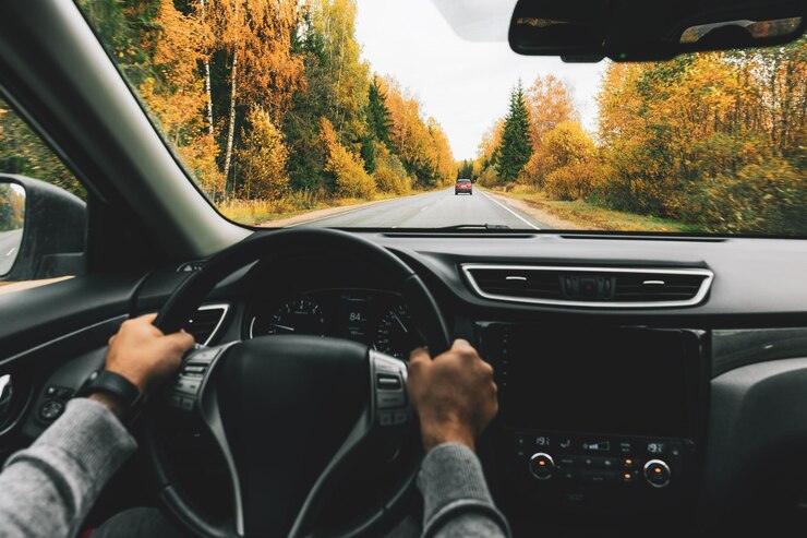 Foto homem dirigindo carro na estrada rural no outono