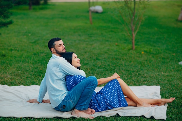 Homem e mulher adulta jovem casal piquenique no prado de grama verde no parque.