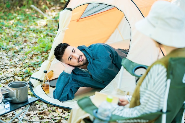 Homem e mulher curtindo acampar na floresta