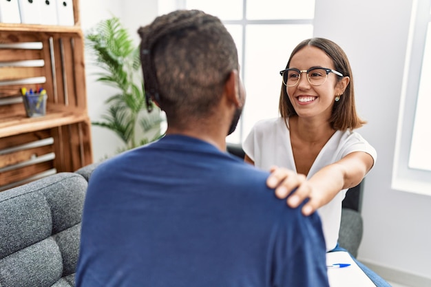 Homem e mulher tendo sessão de psicologia sentado no sofá na clínica de psicologia