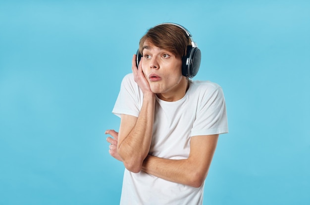 Homem emocional com camisa branca usando fones de ouvido música moda foto de alta qualidade