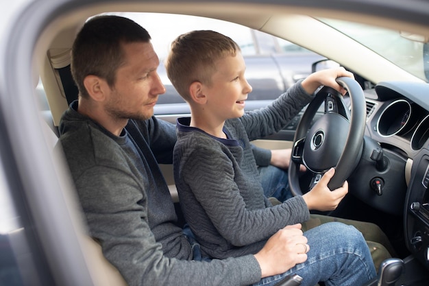 Foto homem ensinando o filho a conduzir carro
