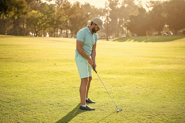 Homem esportivo jogando golfe no jogo de esporte de grama verde