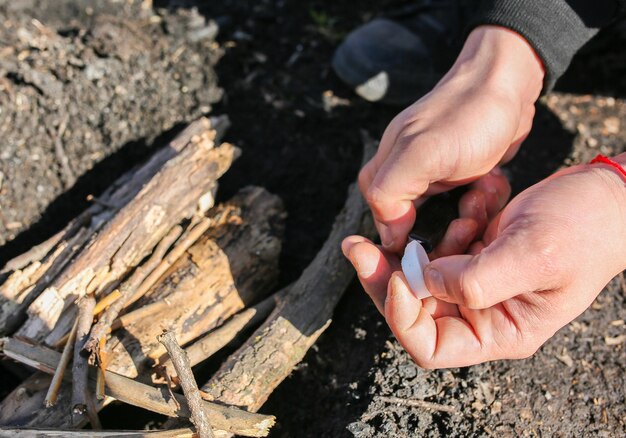 Homem está fazendo fogo de álcool sólido Turista na natureza ao ar livre Lenha para preparar comida