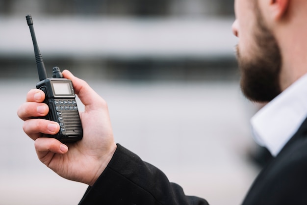 Foto homem falando através de segurança walkie-talkie