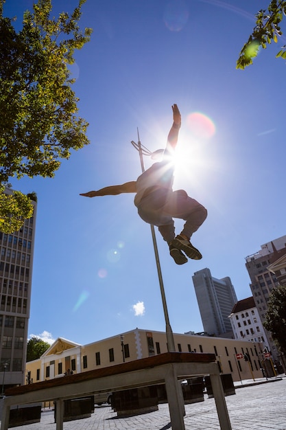 Foto homem fazendo parkour na cidade