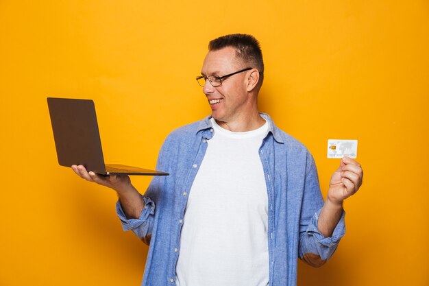 Homem feliz, segurando o cartão de crédito.