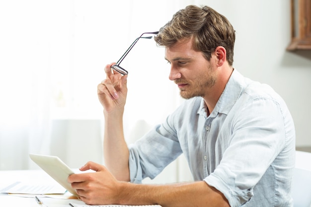 Homem frustrado usando tablet digital no escritório