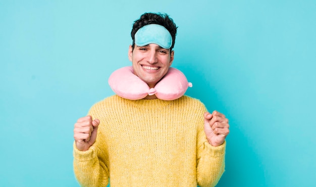 Homem hispânico bonito se sentindo chocado rindo e comemorando o conceito de passageiro de voo de sucesso