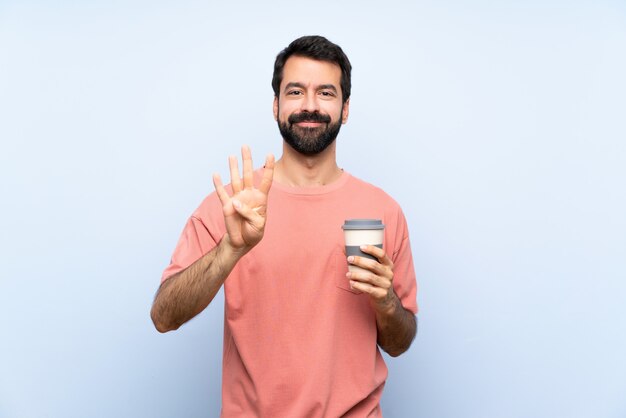 Homem jovem, com, barba, segurando, um, levar, café, ligado, azul, feliz, e, contar, quatro, com, dedos