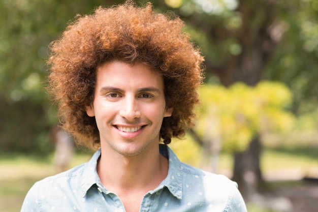 Homem jovem, sorrindo, câmera, parque