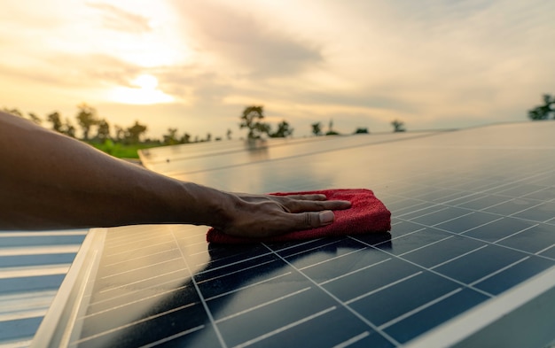 Homem limpando painel solar no telhado Manutenção do painel solar ou módulo fotovoltaico Energia sustentável