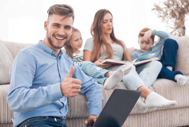 Homem moderno com laptop mostrando o polegar para cima de pessoas e tecnologia