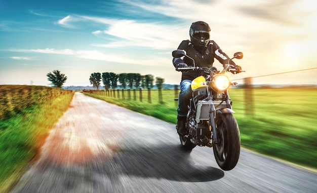 Homem montando motocicleta na estrada contra o céu