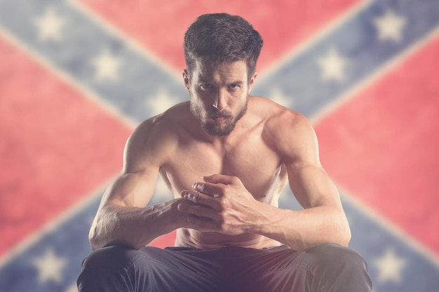 Homem musculoso com a bandeira da Confederação atrás