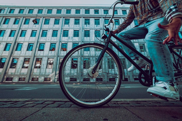 Homem na bicicleta com prédio ao fundo