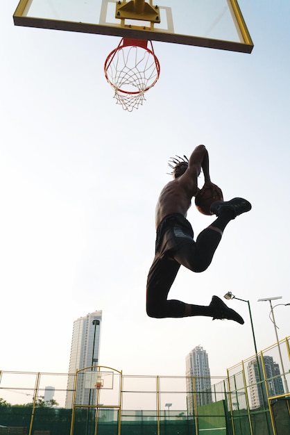 Homem negro a jogar basquetebol .