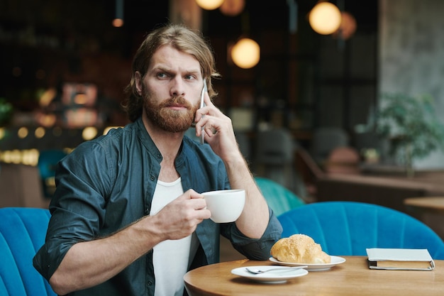 Homem ocupado discutindo projeto por telefone