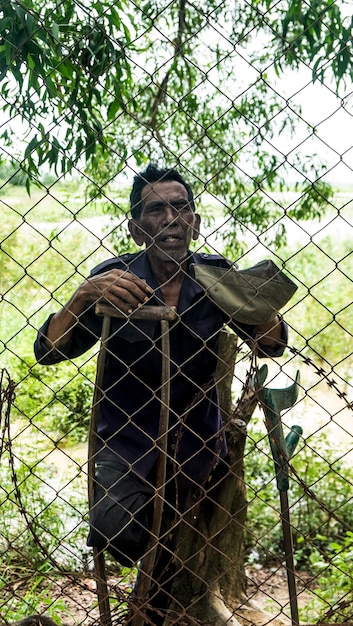 Foto homem olhando através da cerca